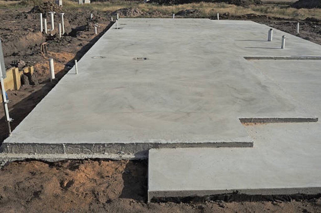 Newly poured concrete slab foundation with smooth finish and structural layout in Columbia Station, OH